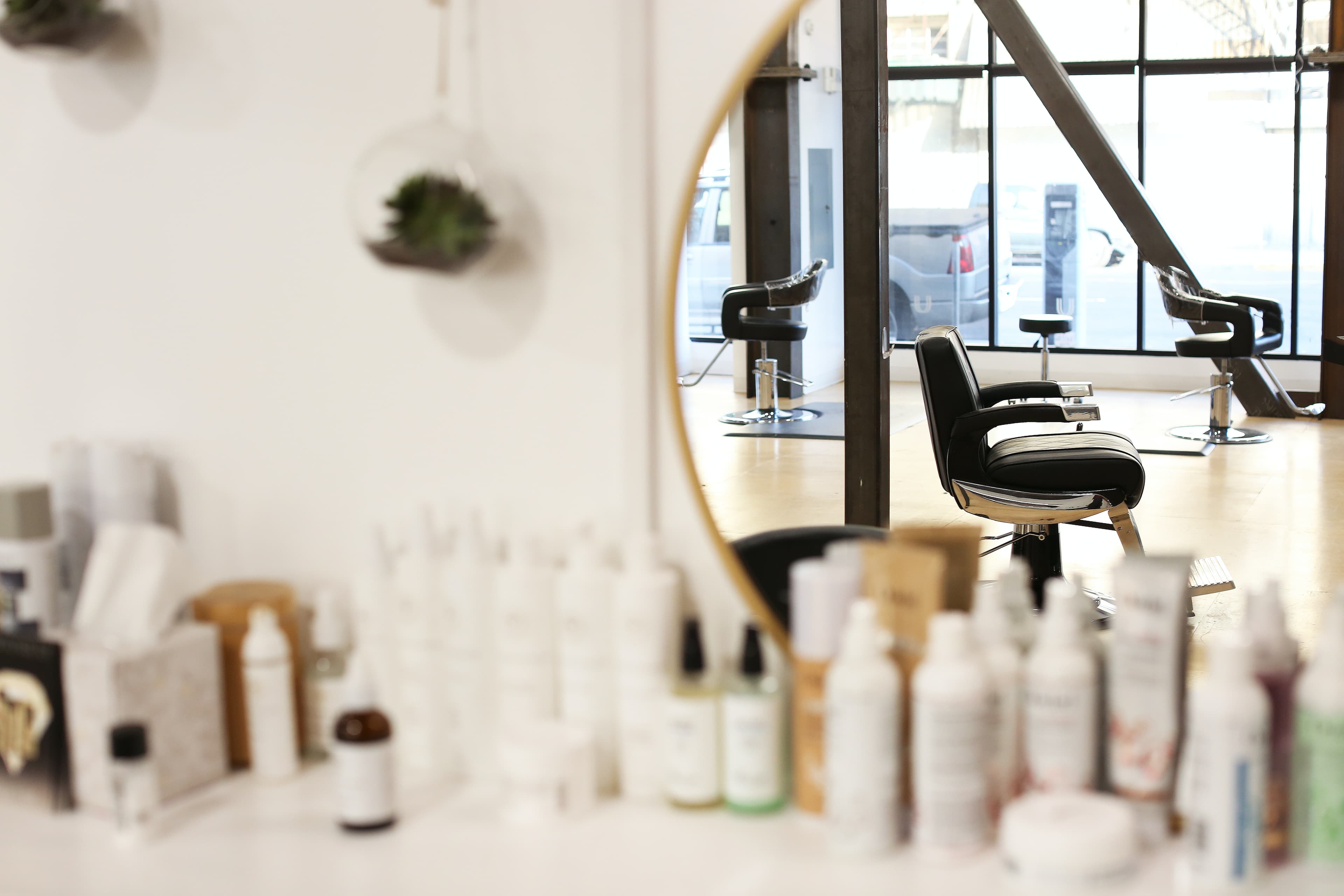 A salon chair in a mirror.